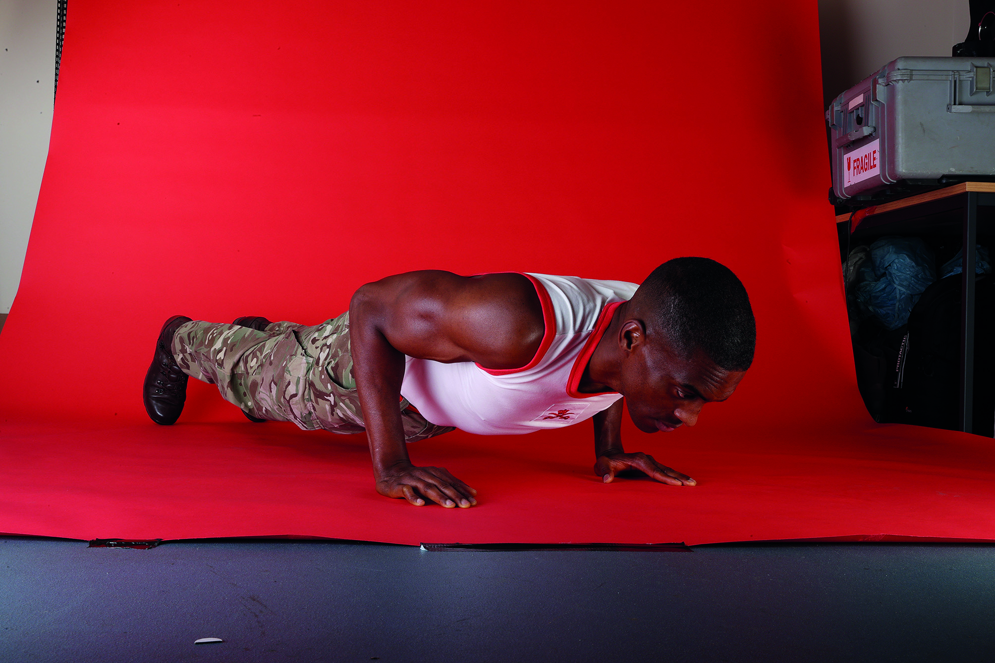 Man holding a push up with red background