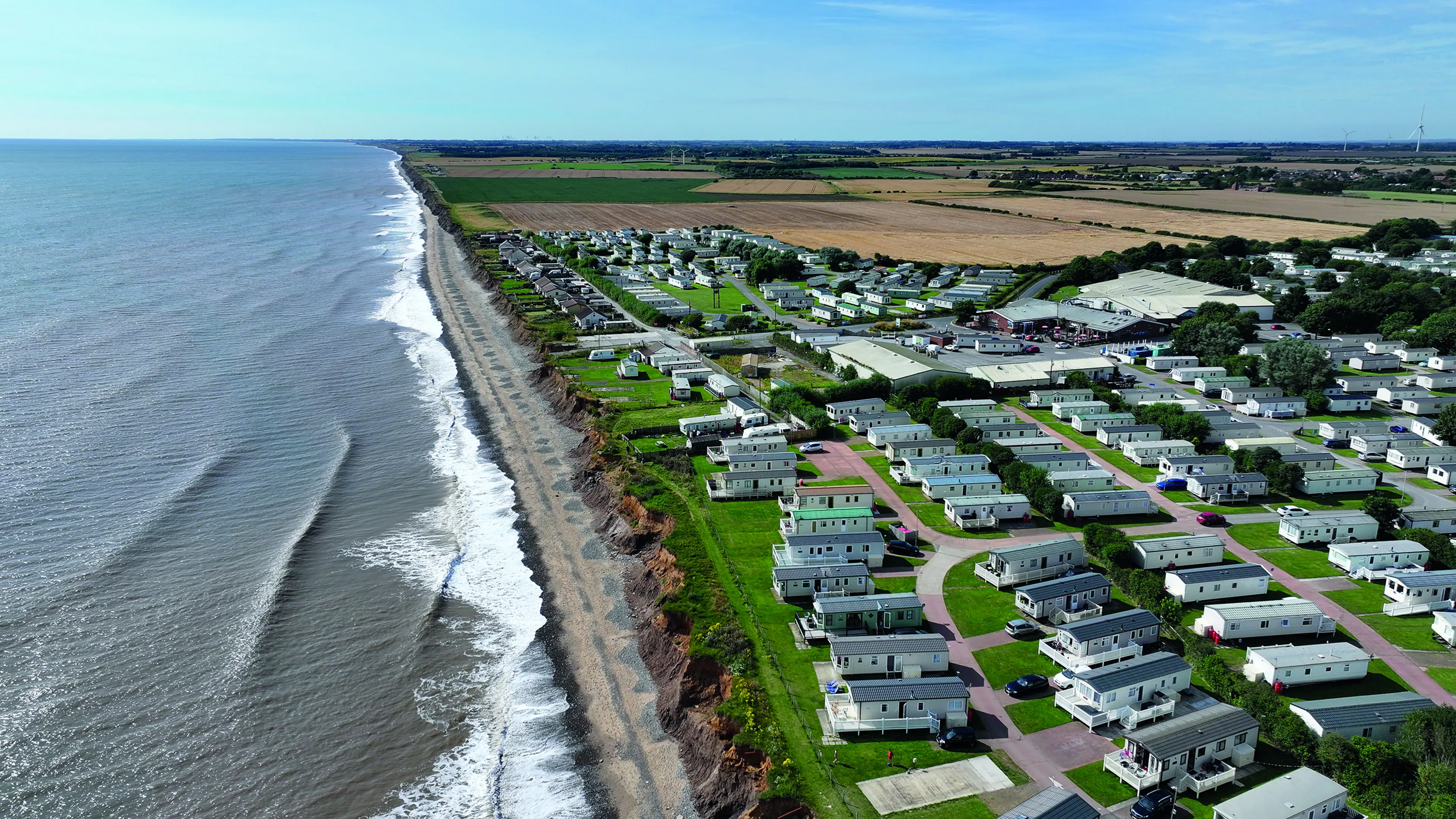 Aerial view of caravan park next to the sea