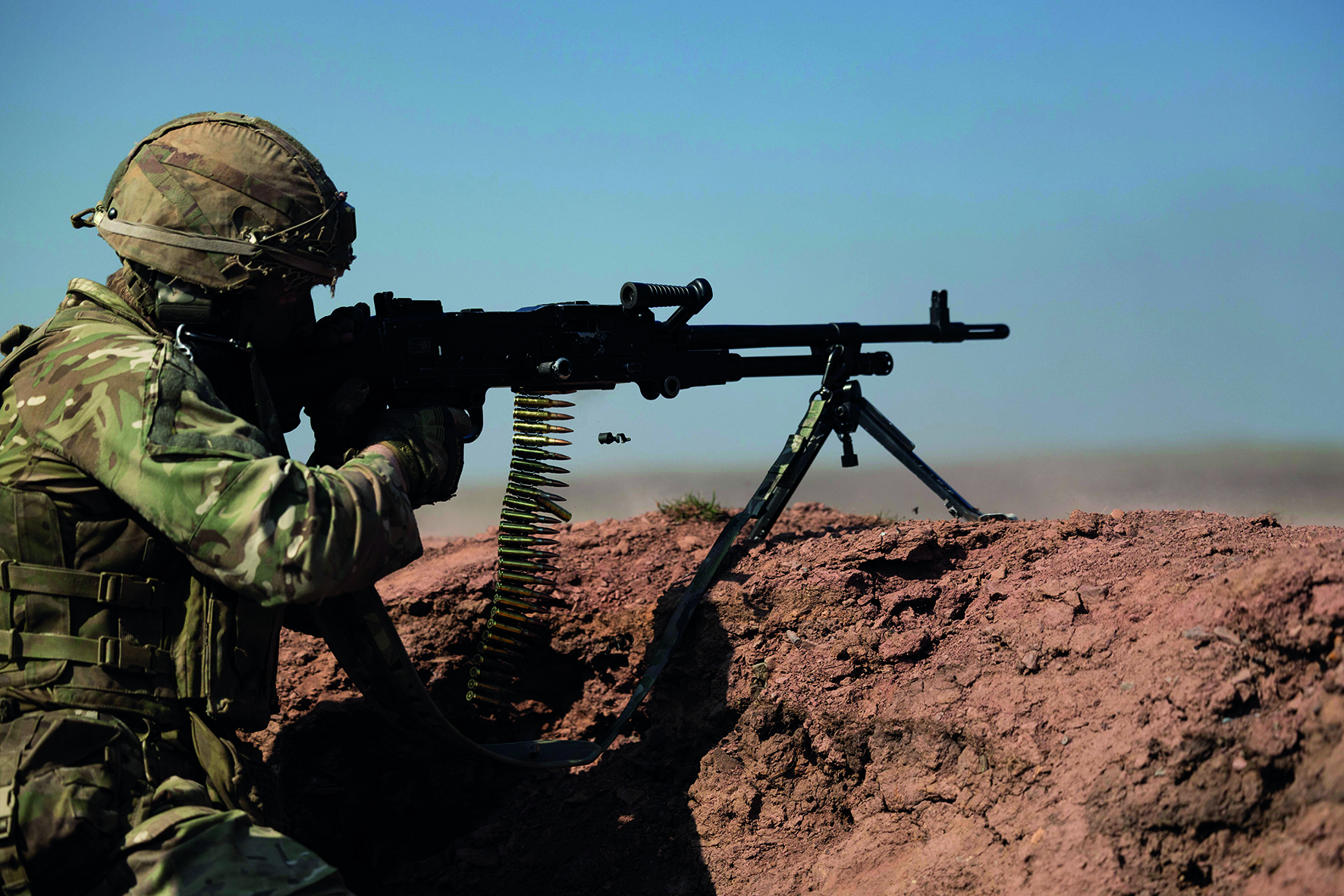 Soldier in desert, aiming large gun