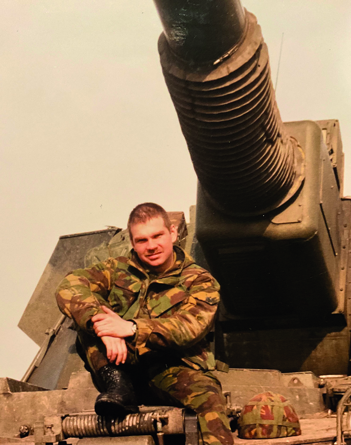 Old photo of soldier in front of tank