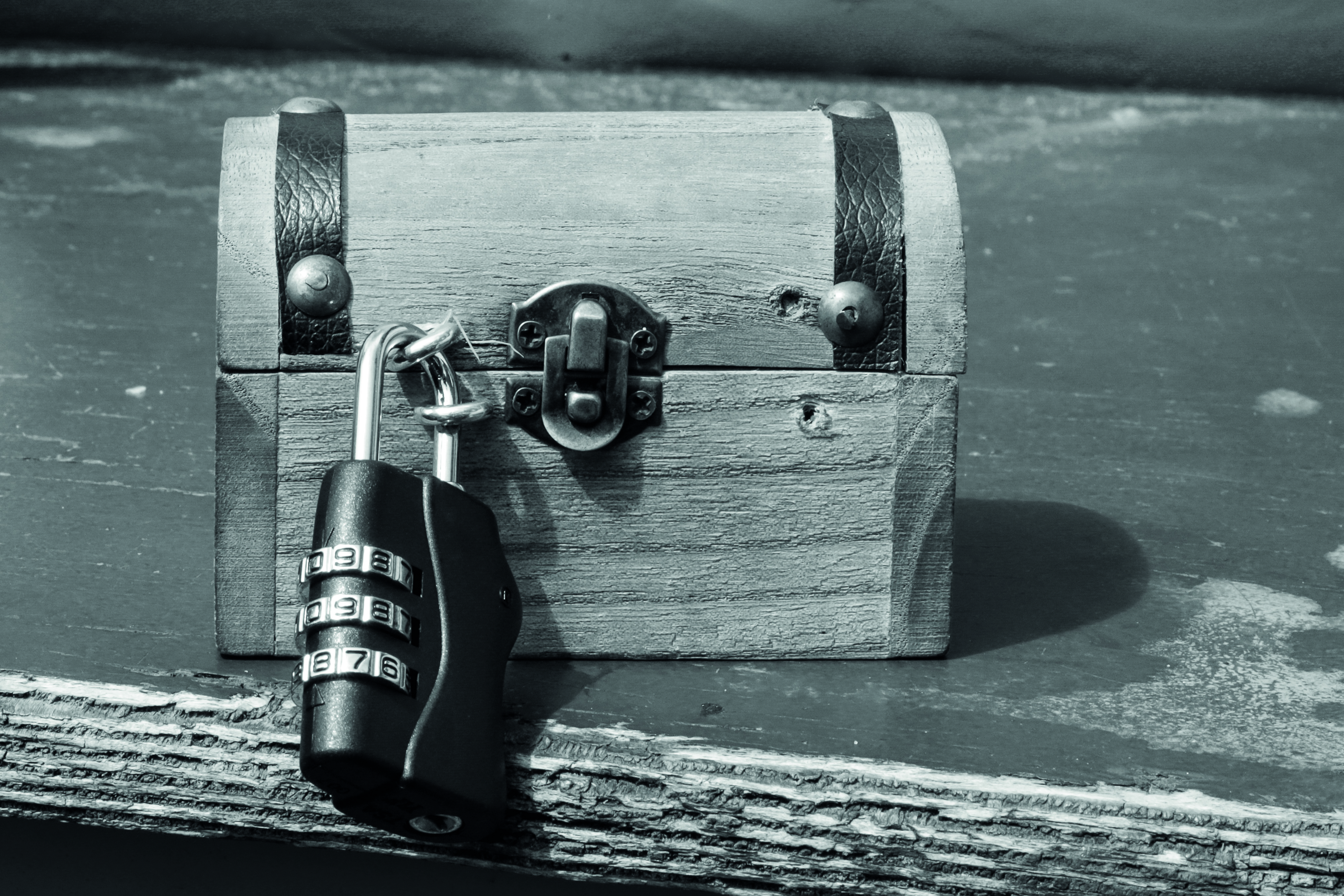 Black and white image of wooden chest with lock