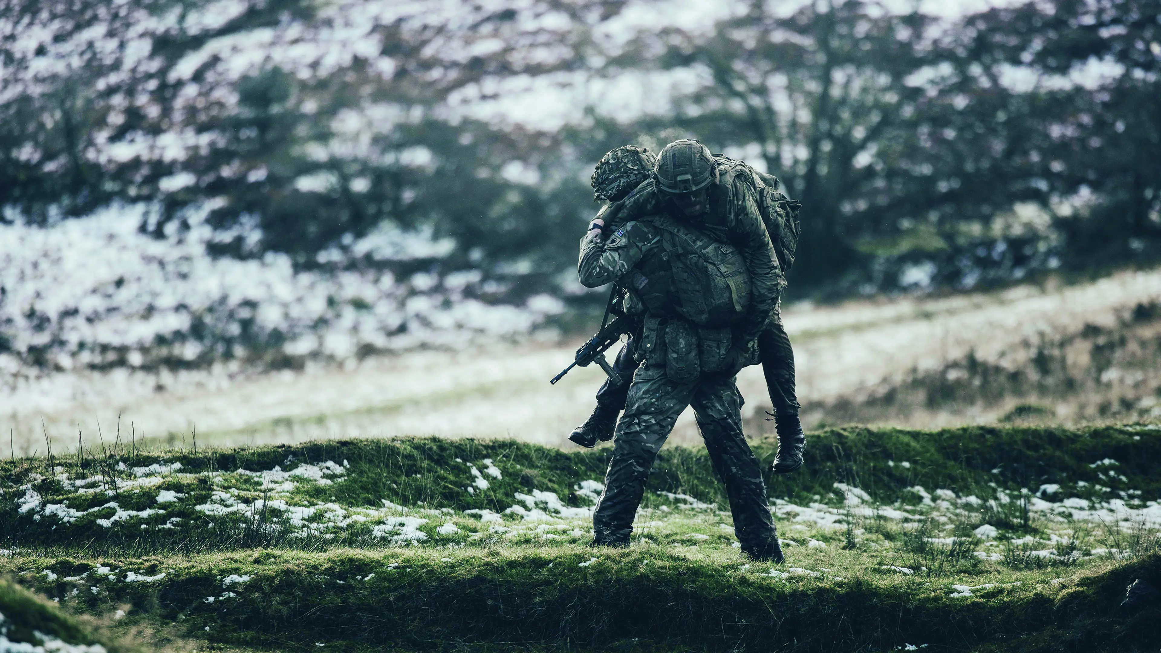 A soldier carrying another soldier on his back