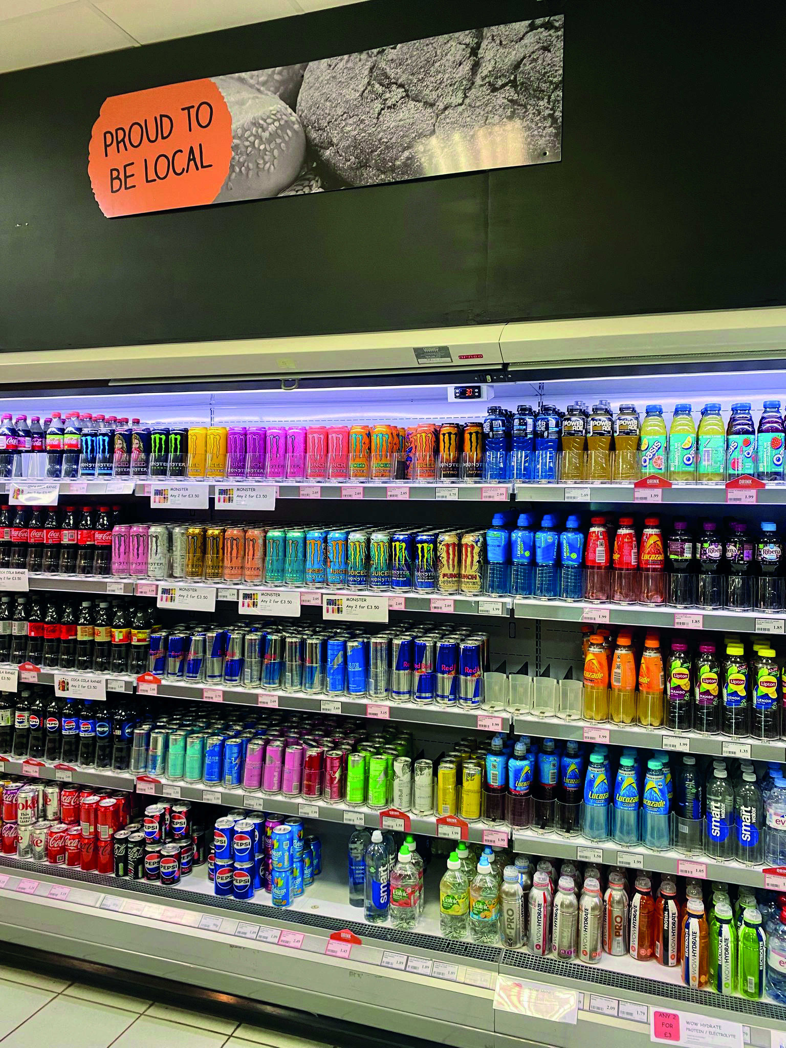 Shop shelves filled with multiple multicolour energy drinks