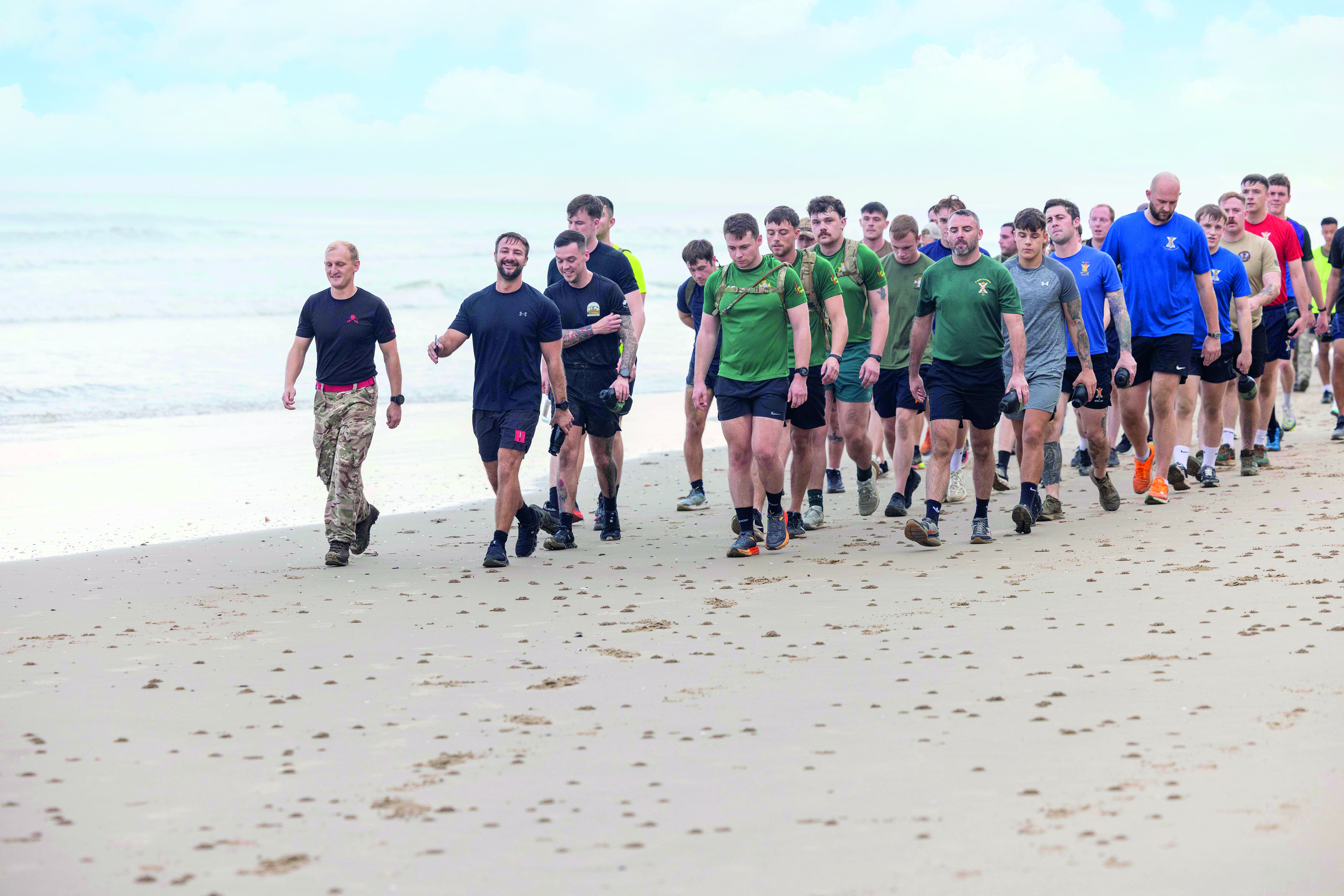 Group of men walking on the beach