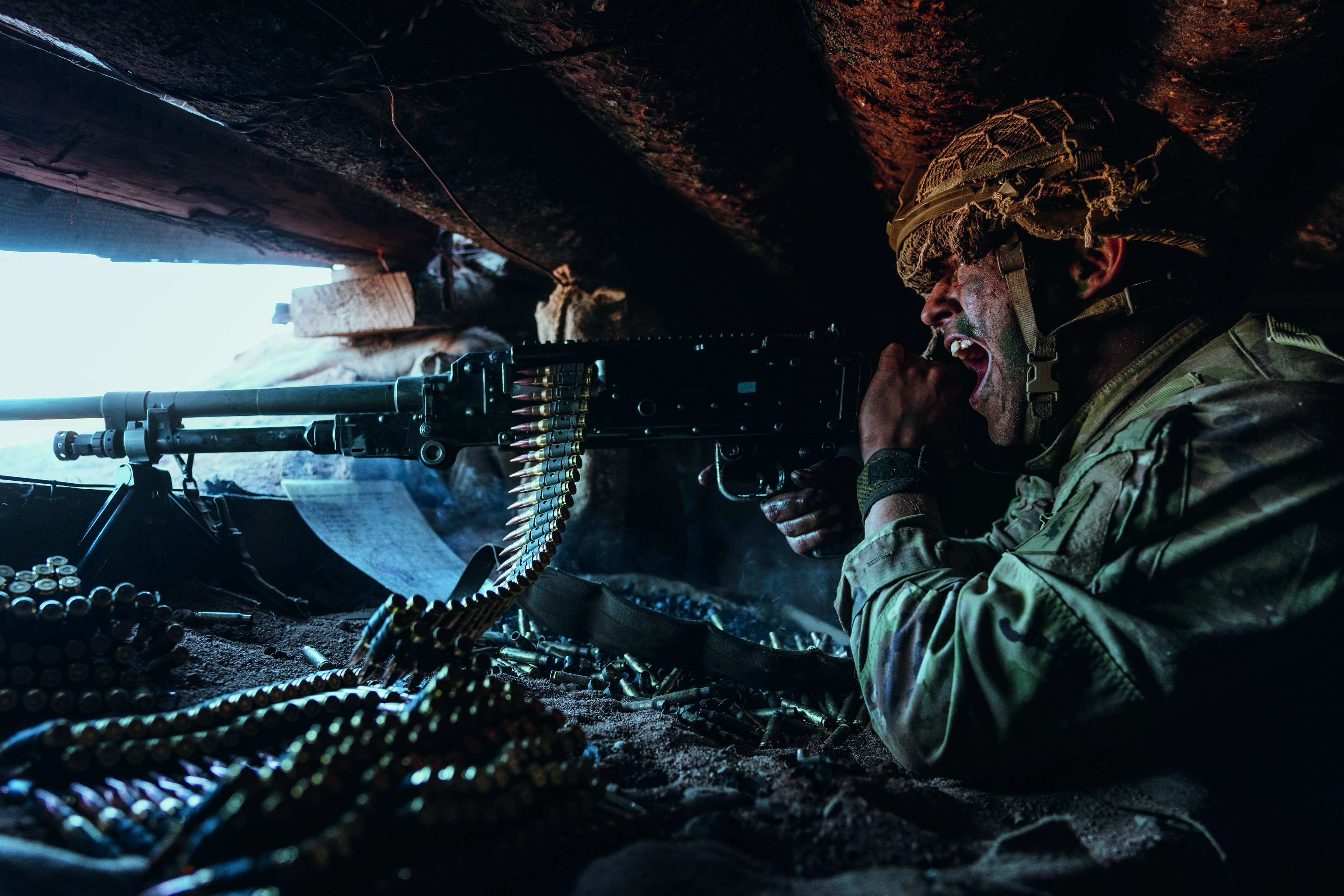 Camouflaged soldier, aiming gun and shouting