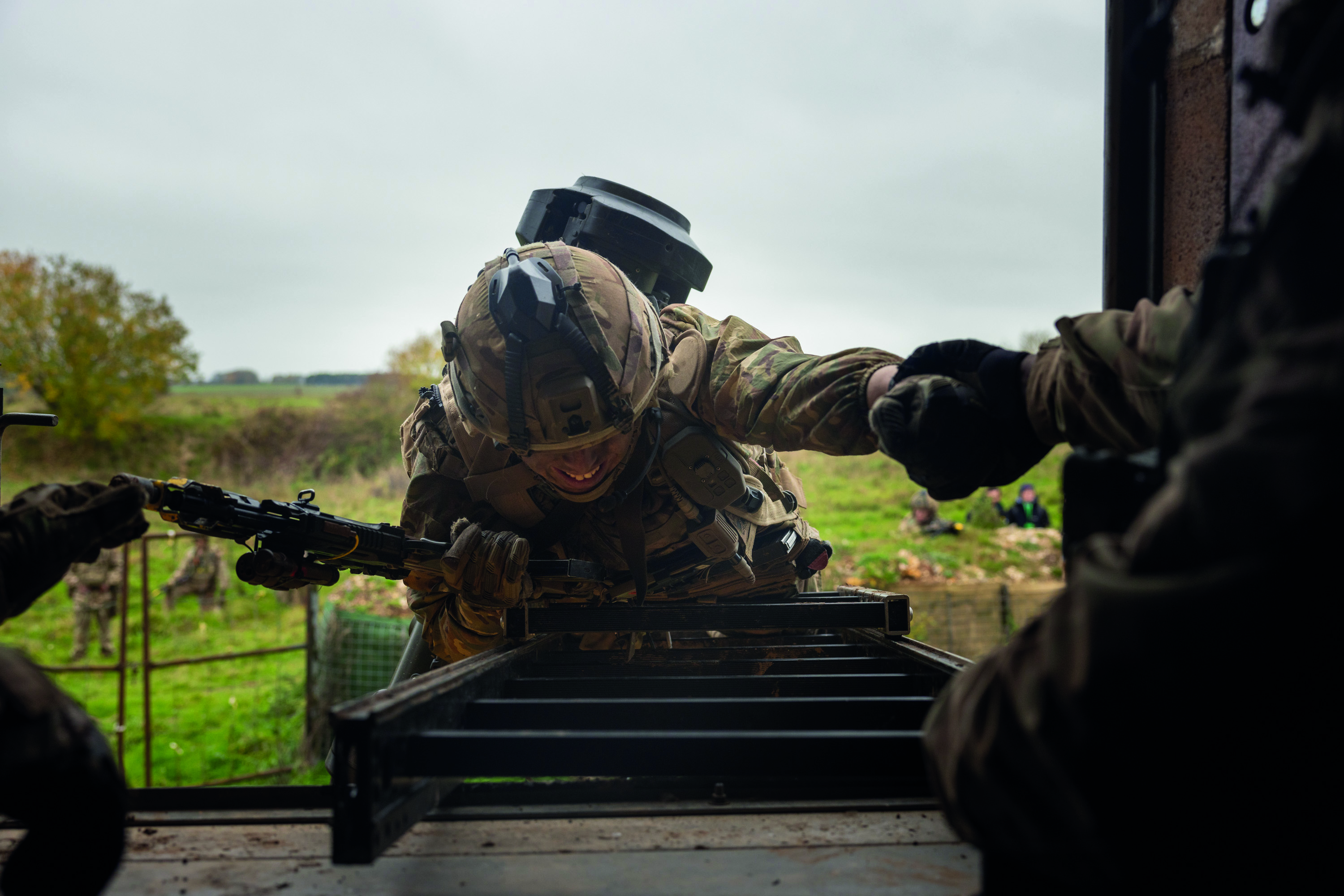 Uniformed soldier climbing up wooden ladder