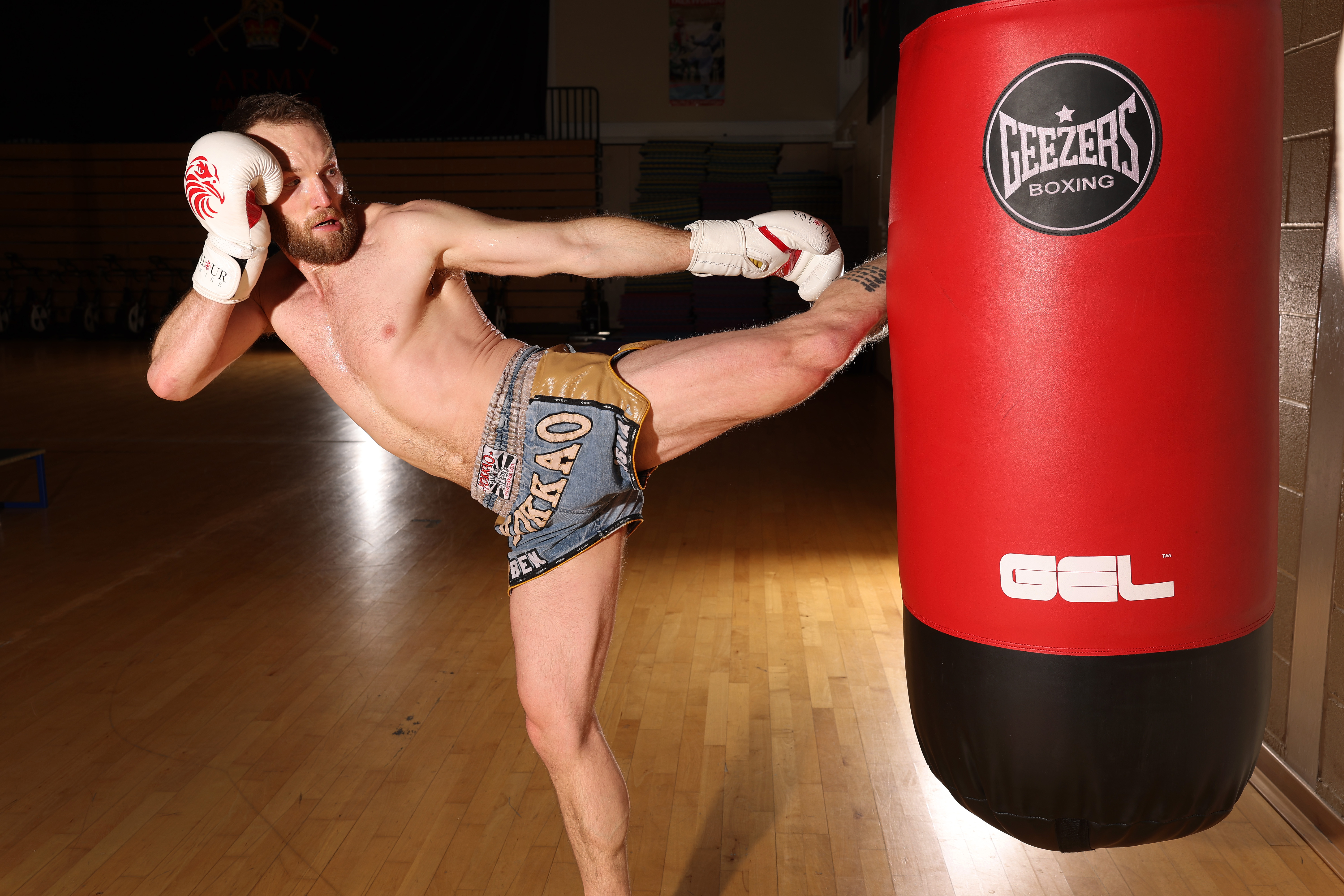 Man kickboxing a punch bag 