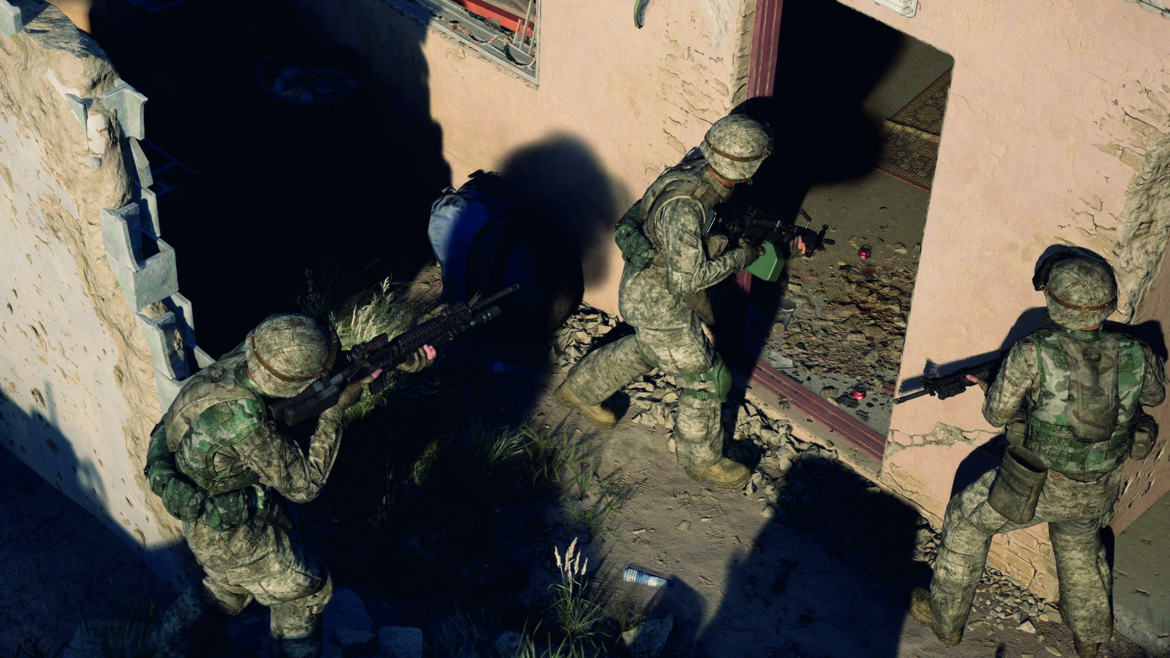 Aerial view of 3 soldiers entering a concrete building 