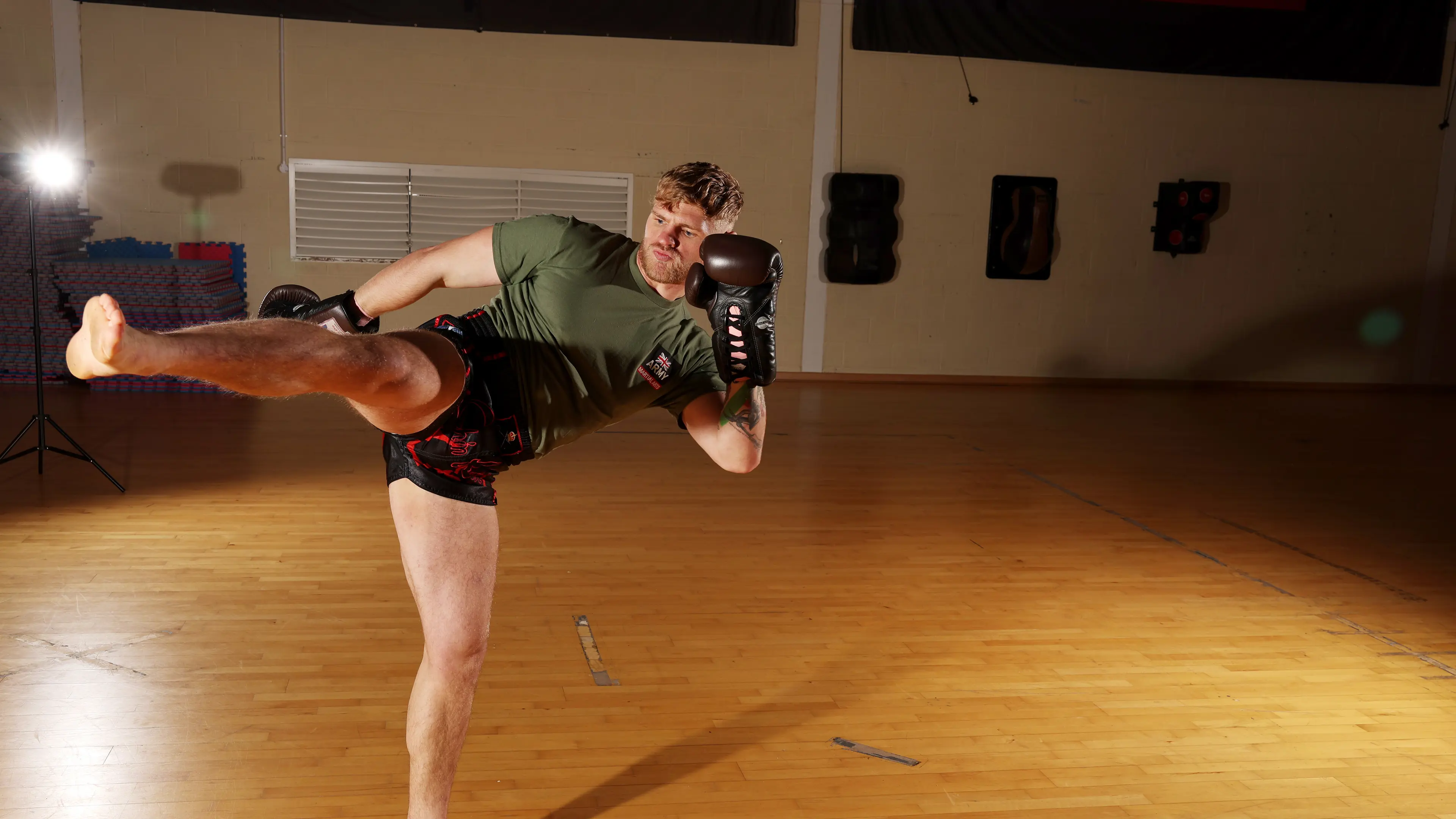 Man practicing kickboxing in a gymnasium